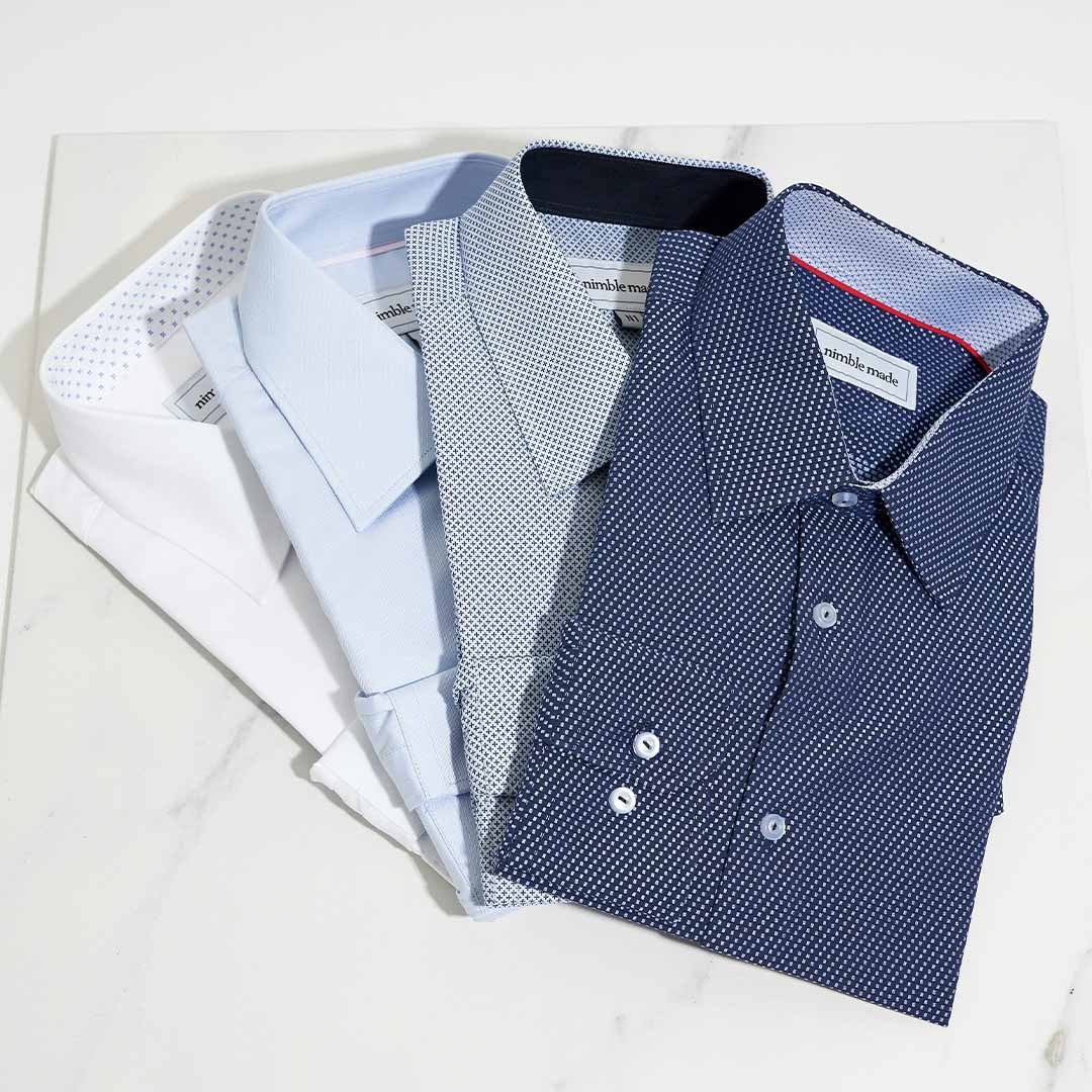 4 camisas para hombre sobre tela blanca.