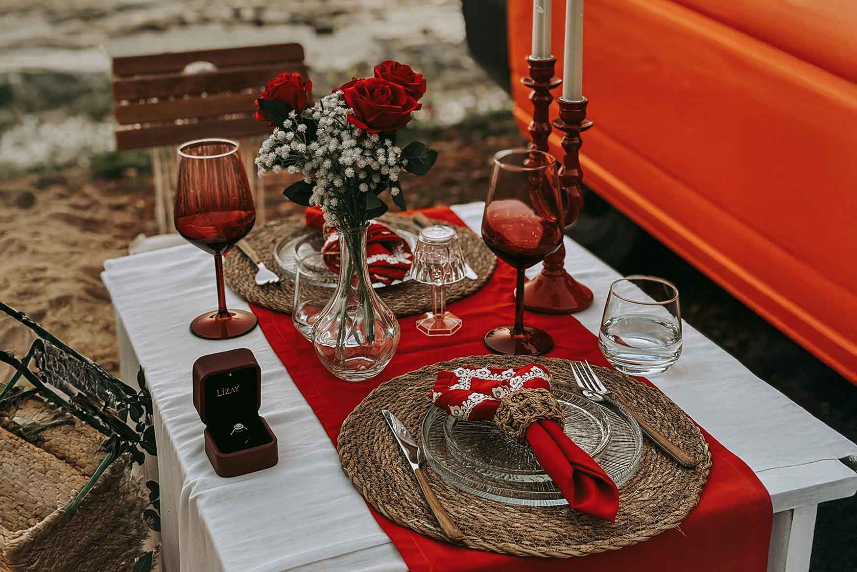 Picnic romántico en una mesa con artículos de color rojo.